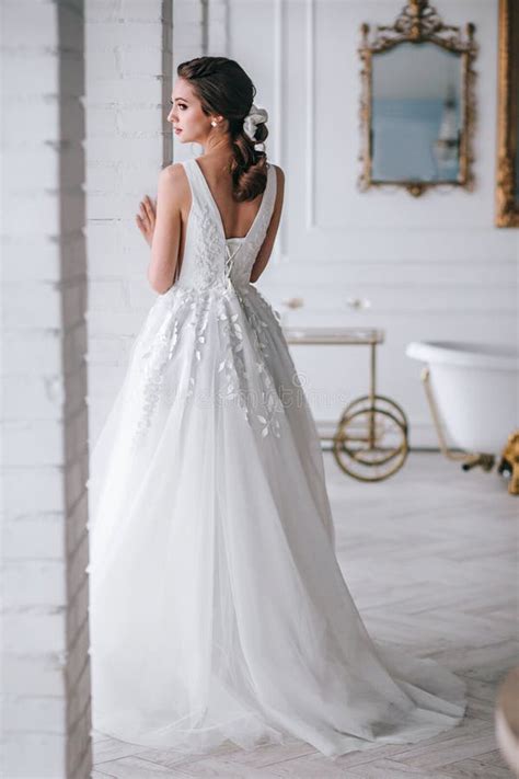 Back View Of The Elegant Blonde Bride Dressed In A White Dress In Studio Stock Photo Image Of