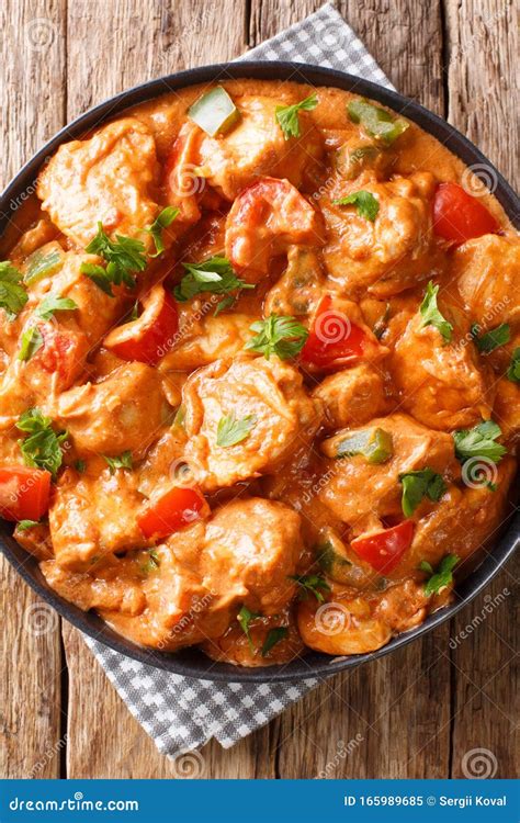 West African Chicken Mafe In Peanut Sauce Close Up In A Plate Vertical