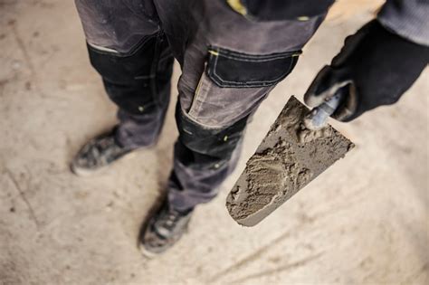 Premium Photo Close Up Of A Builder S Hand Holding A Trowel On A