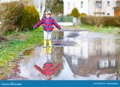 Little Kid Boy Jumping Through Rain Puddle Stock Image Image Of Male