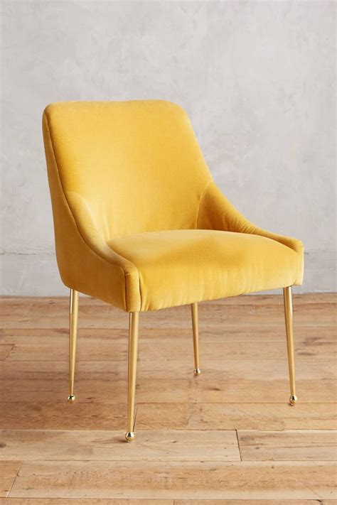 A Yellow Chair Sitting On Top Of A Wooden Floor