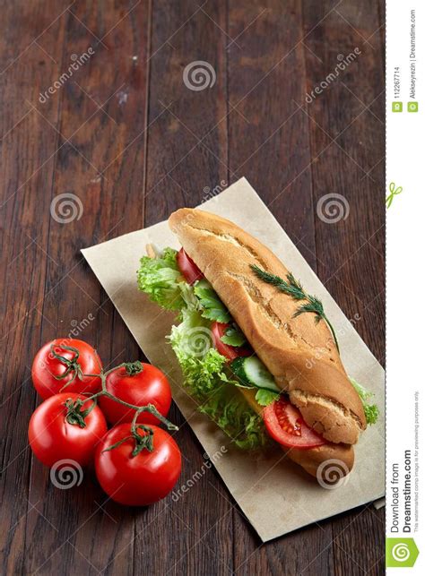 Fresh Sandwich With Lettuce Tomatoes And Cheese Served On Paper Plate