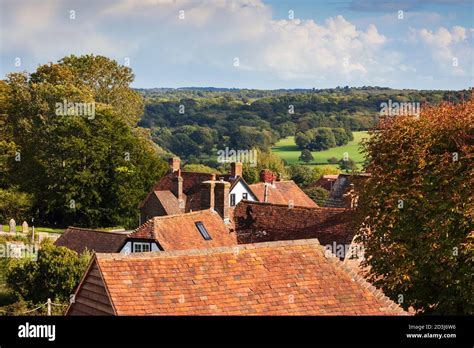 View Over Cottage Rooftops And High Weald Landscape In Summer Burwash