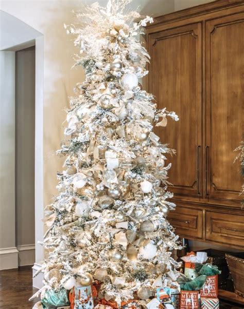 A White Christmas Tree With Silver And Gold Ornaments