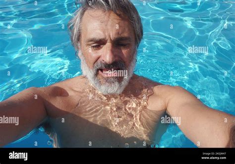 Unhappy Mature Man In A Swimming Pool Stock Photo Alamy