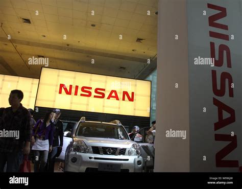 File Visitors Look At Cars At A Stand Of Nissan At An Auto Fair In