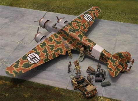 An Airplane With Camouflage Paint On It Sitting On The Ground