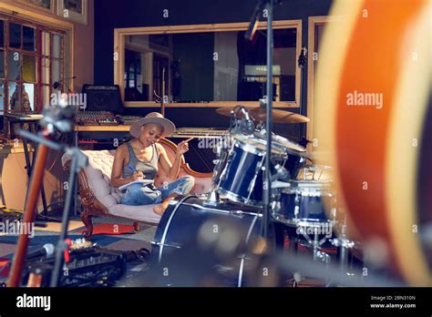 Female Musician Song Writing In Recording Studio Stock Photo Alamy