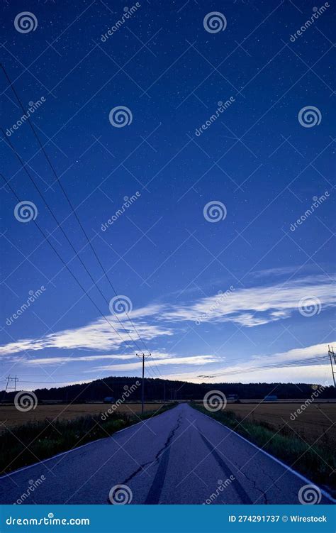 Long Desolate Stretch Of Highway With Tall Power Lines Running