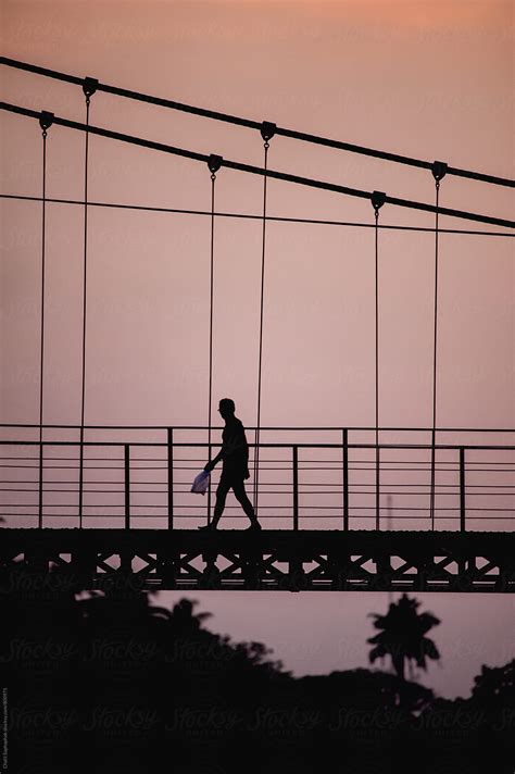 Man Walking Across The Bridge By Stocksy Contributor Chalit