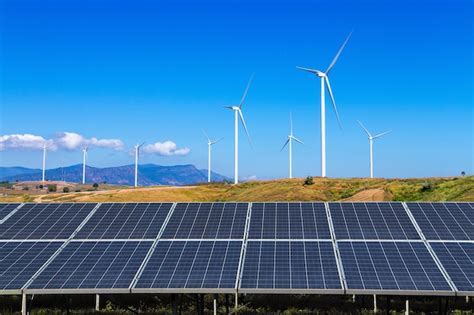 Premium Photo View Of Wind Turbines And Solar Panels On Field Against Sky