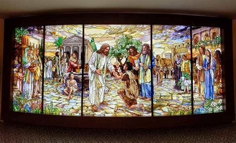 A Large Stained Glass Window With Jesus And Other People