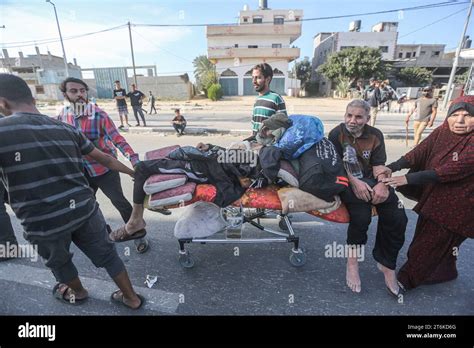 Palestinians Push Injured Elderly People On A Bed They Took From The Hospital As They Flee With