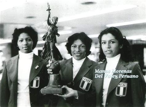 Three Women In Suits Holding Up A Trophy