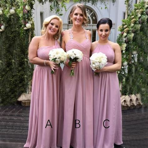 Three Bridesmaids In Pink Dresses Posing For The Camera With Their