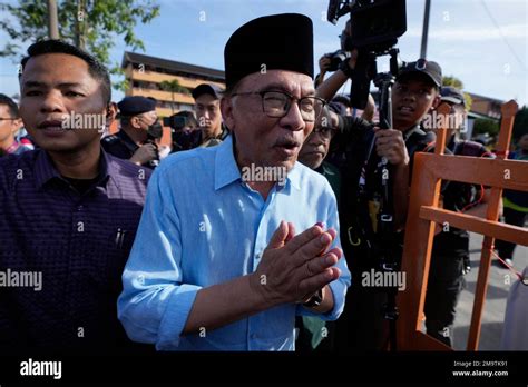 Malaysian Opposition Leader Anwar Ibrahim Gestures As He Walks After