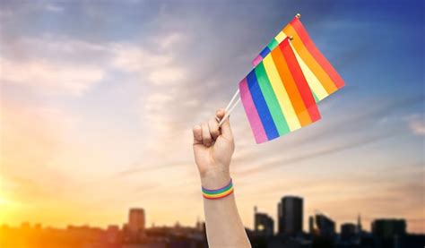 Premium Photo Hand With Gay Pride Rainbow Flags And Wristband