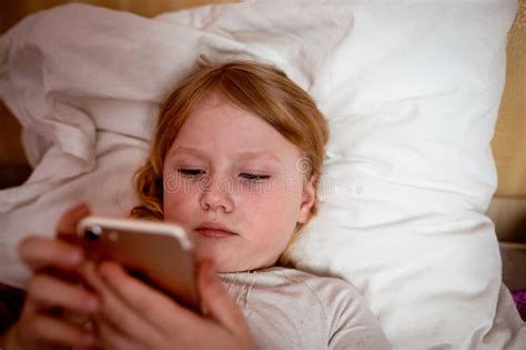 Young Girl Using Smartphone In Bed At Night Stock Image Image Of