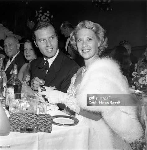 American Singer Dinah Shore And Her Husband George Montgomery Sit