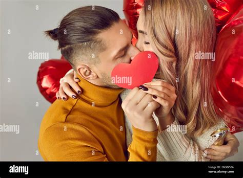 Happy Couple In Love Celebrating Valentines Day And Kissing Behind A