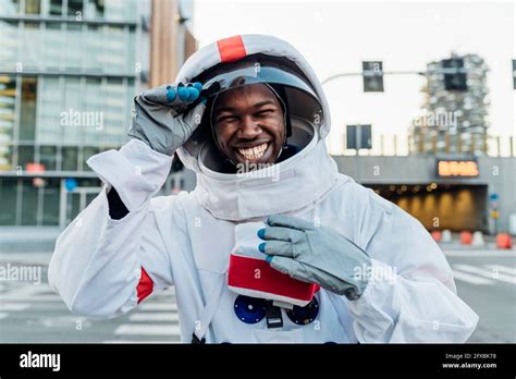 Cheerful Male Astronaut Holding Space Helmet Stock Photo Alamy