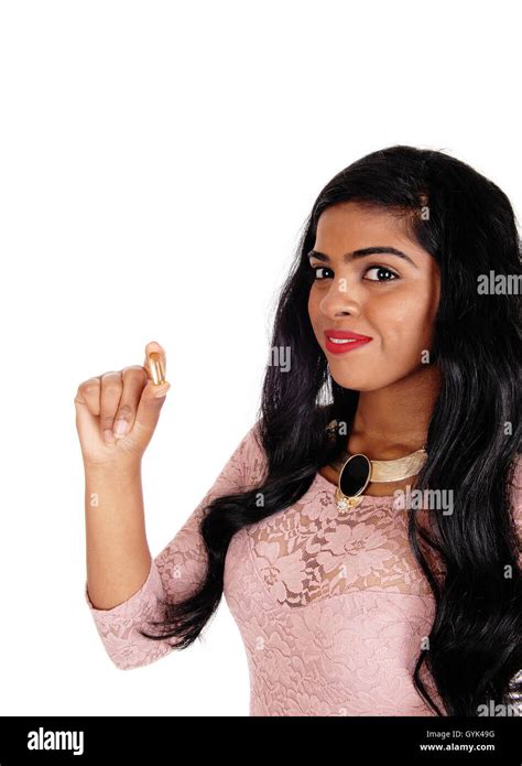 A Beautiful Young Woman With Long Black Hair Holding A Vitamin Pill In