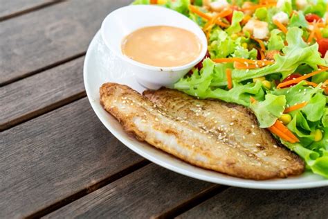 Premium Photo | Salad with fried fish fillet