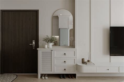 A White Shoe Cabinet with Wall Attached Mirror in the Foyer Space Stock ...