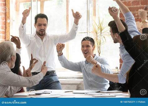 Excited Diverse Colleagues Celebrate Team Win In Office Stock Image