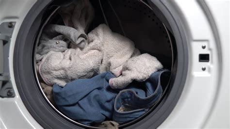 Girl Loads Dirty Things Into The Washing Machine Close Up Stock Image