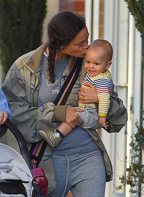 Thandie Newton Plants A Loving Kiss On Baby Booker During A Casual Walk