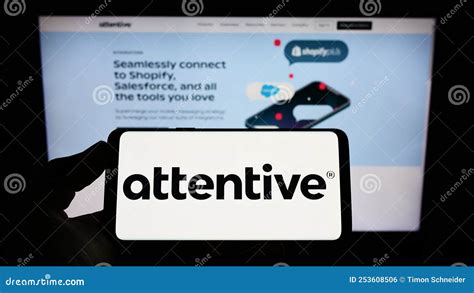 Person Holding Smartphone With Logo Of Us Marketing Company Attentive