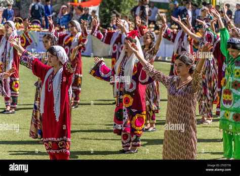 The Tajik Girls In Colorful National Outfits Are Dancing During The