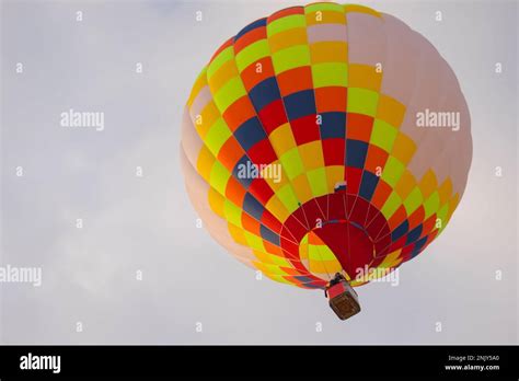 Colorful Hot Air Balloon Flying Against Grey Sky At Winter Aerostat Festival Stock Photo Alamy