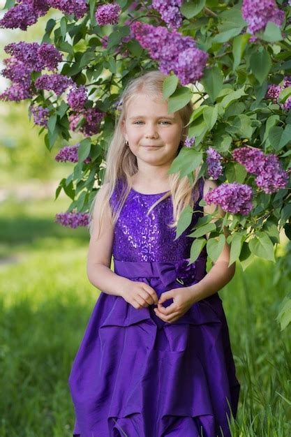 Premium Photo A Girl In A Lilac Dress In A Blooming Park Next To A