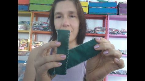 A Woman Holding Up A Piece Of Green Material