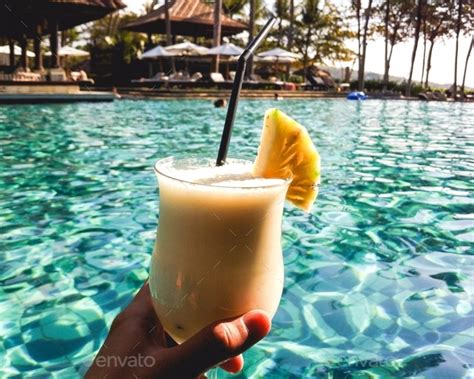 Drinking A Pina Colada At A Resort Swimming Pool While On Vacation In