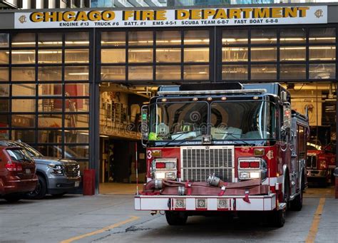 Illuminated Red Fire Truck Parked In Front Of The Chicago Fire