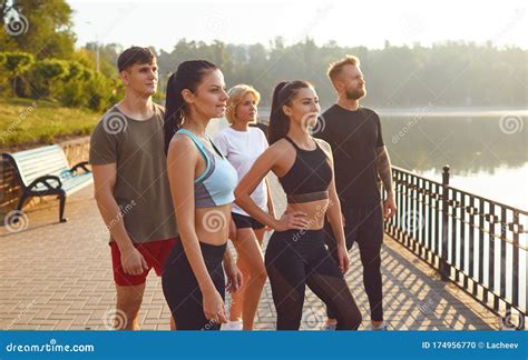 A Group Of Athletes Training In The Park Stock Photo Image Of People