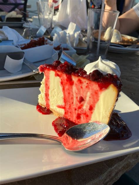 A Piece Of Cheesecake On A Plate With A Fork