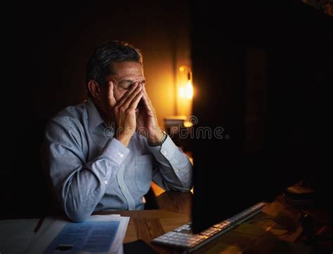 Mature Businessman Headache And Night With Anxiety On Computer For