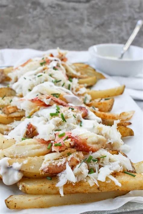 Baked Fries On A Serving Platter Topped With Melted Smoked Gouda And