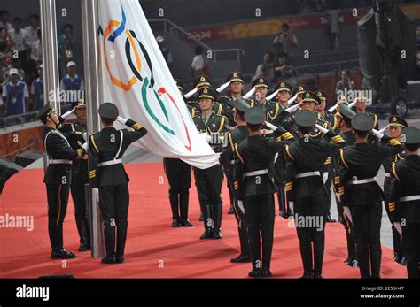 Members of the Chinese military raise the Olympic flag next the China ...