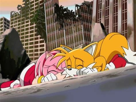 Two Cartoon Characters Laying On The Ground Next To Each Other In Front