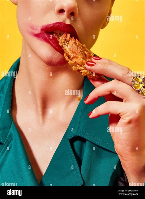 Cropped Image Of Woman In Green Coat With Red Lipstick Smudge Eating