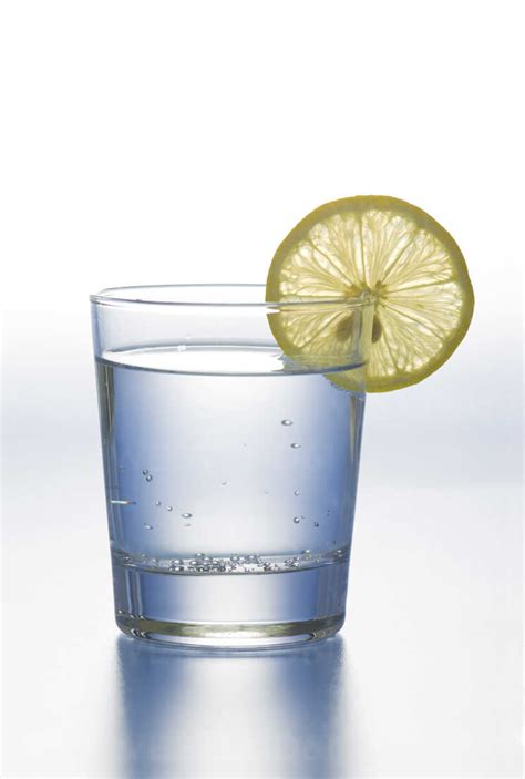 Glass Of Water With Lemon Slice On White Background Stock Photo