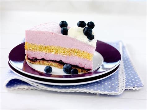 A Piece Of Cake On A Plate With Blueberries