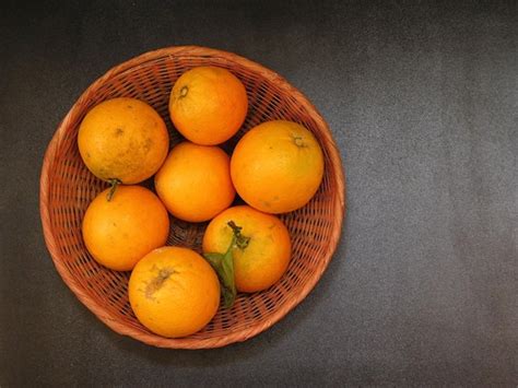 Premium Photo High Angle View Of Orange Fruits In Basket On Table