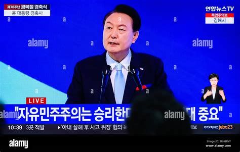 A Tv Screen Shows The South Korean President Yoon Suk Yeol Delivering A