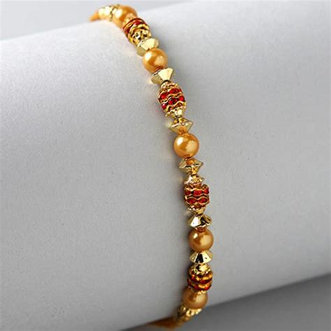 Send Golden Red Thread Rakhi And Kaju Katli Box Online